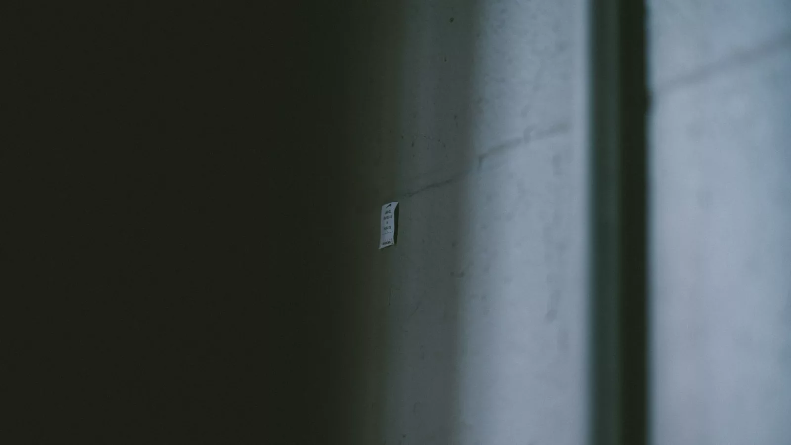 A light switch on a wall in a dark room