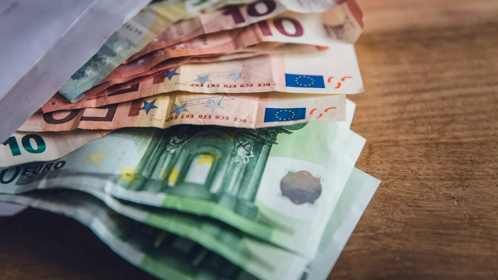 Euro banknote collection on wooden surface