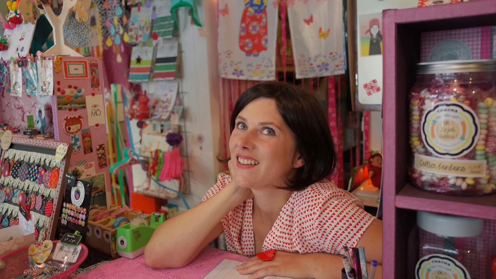 Woman leaning on pink desk