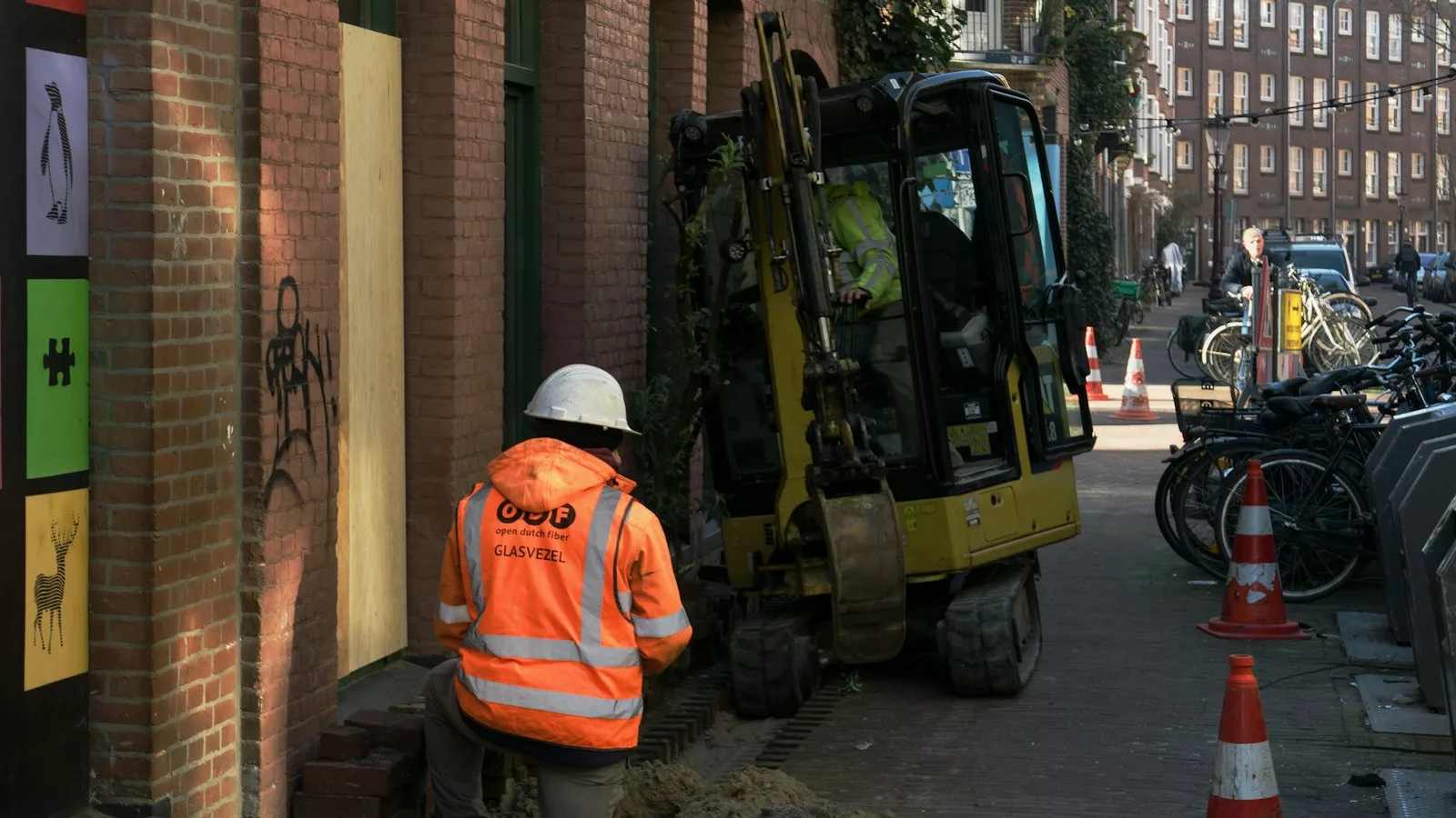 A construction worker standing next to a construction truck